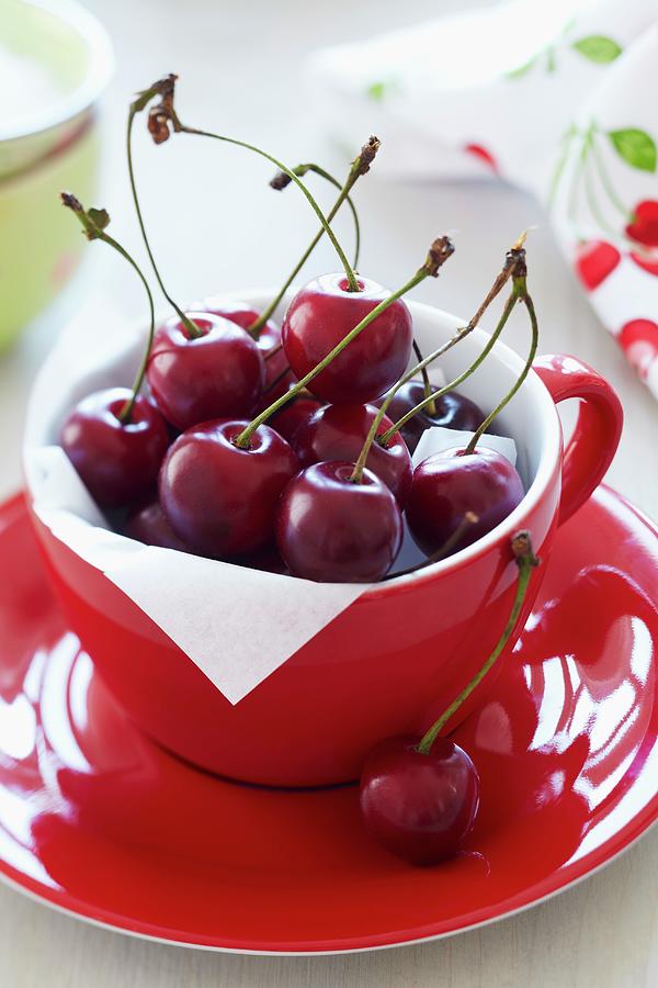 Freshly Picked Cherries In A Red Cup Photograph by Taube, Franziska