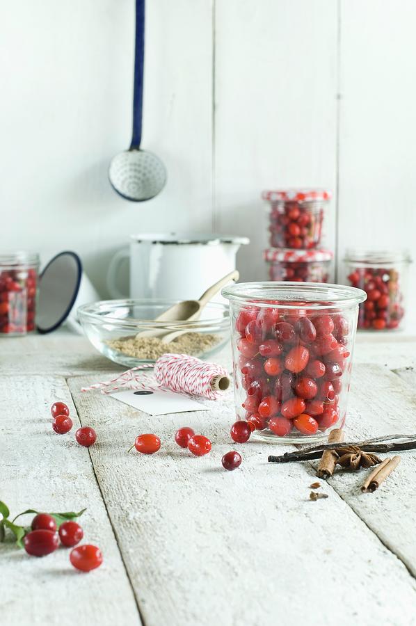 Freshly Picked Cornelian Cherries For Making Jam, Cloves, Anise, Vanilla Pods And Cinnamon Sticks Photograph by Achim Sass