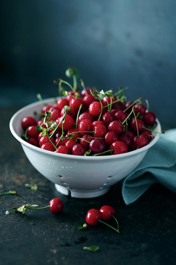 Freshly Picked Sour Cherries In A Porcelain Sieve Photograph by Oliver Brachat