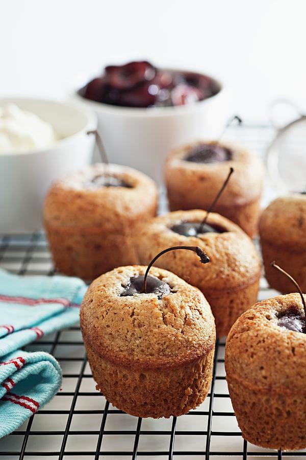 Friands With Cherries On A Wire Rack Photograph by The Food Union