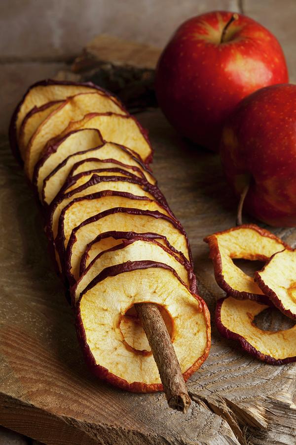 Fried Apple Rings And Fresh Apples On A Wooden Board Photograph by Shawn Hempel