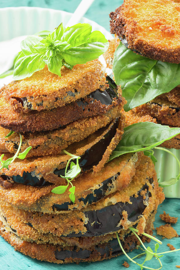 Fried Aubergine Slices, Stacked, With Fresh Herbs Photograph by Charlotte Von Elm