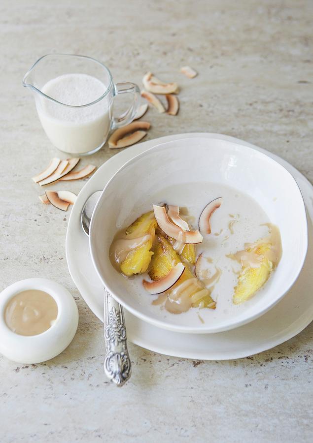 Fried Bananas In A Coconut And Vanilla Soup With A Nut Butter And Honey Sauce Photograph by Great Stock!