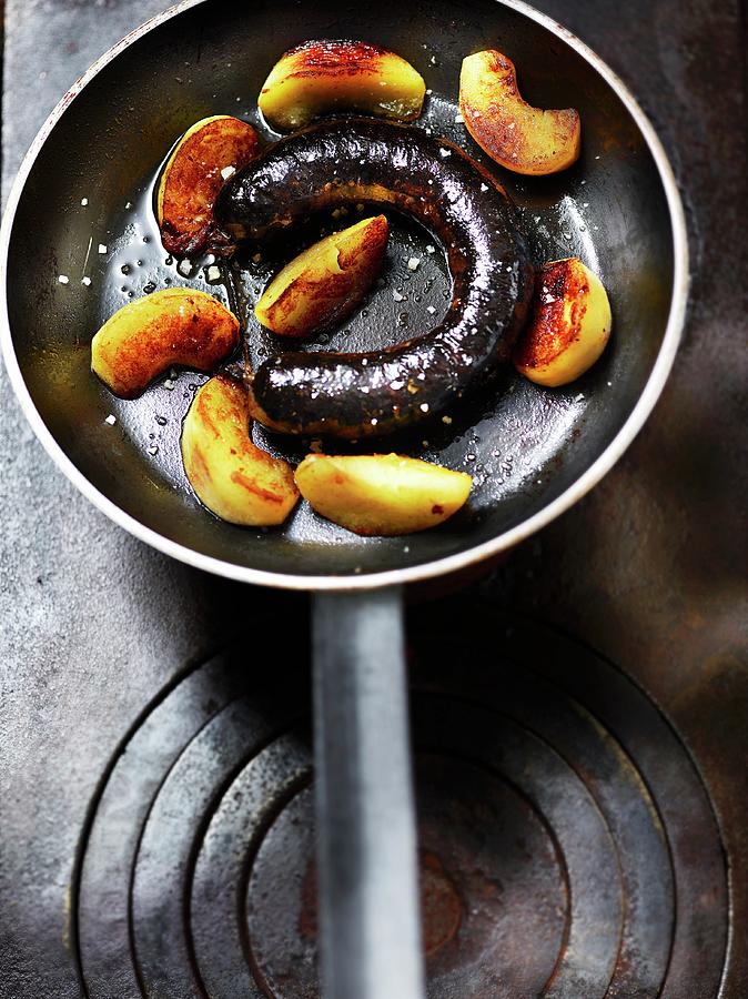 Fried Blood Sausage With Apple Wedges In A Pan Photograph by Frdric Perrin