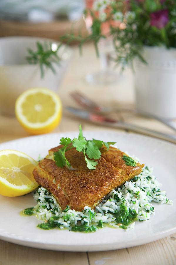 Fried Cod Fillets With A Spicy Coating On A Bed Of Coriander Rice Photograph by Winfried Heinze