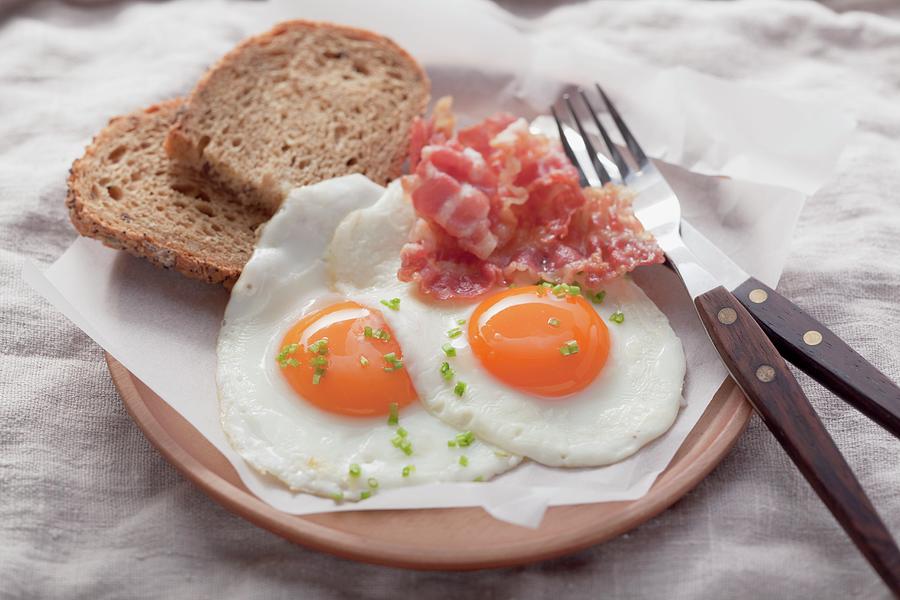 Fried Eggs With Bacon And Bread Photograph by Foodcollection