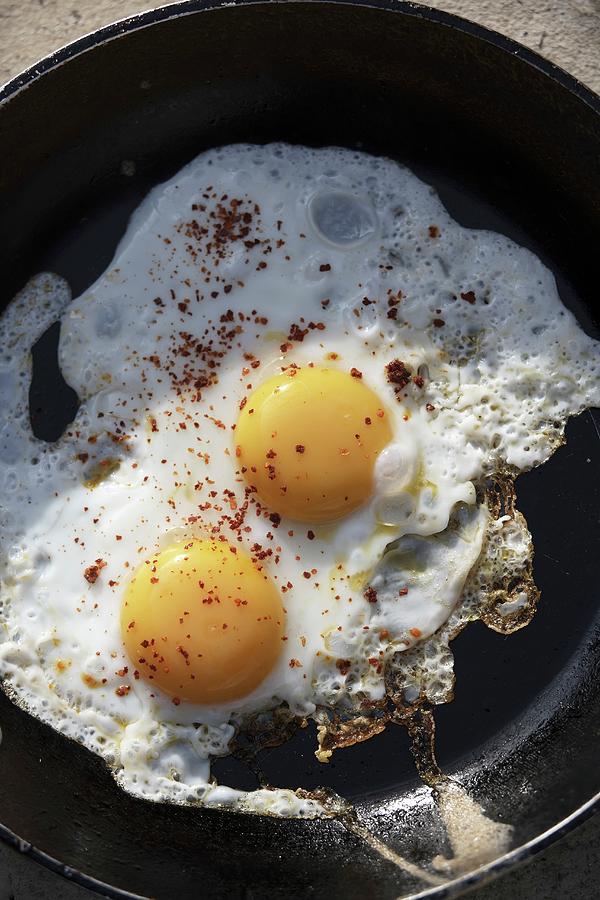 Fried Eggs With Ground Allspice Photograph by Joerg Lehmann