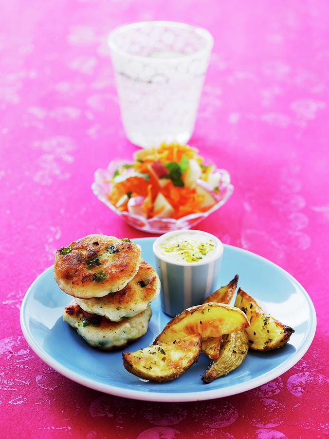 Fried Fish Cakes With Potato Wedges Photograph by Mikkel Adsbl