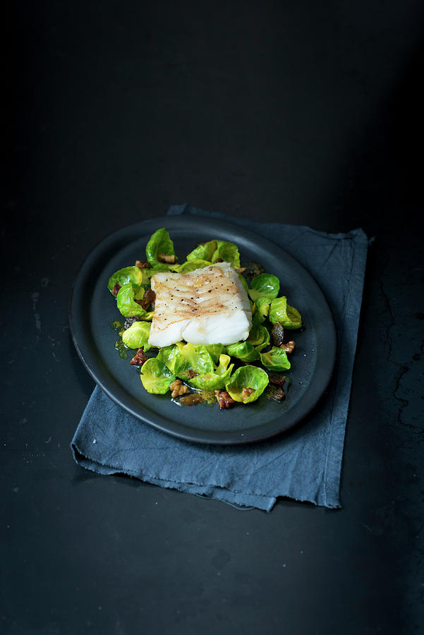 Fried Fish Fillet On Brussels Sprouts With Bacon Photograph by Manuela Rther