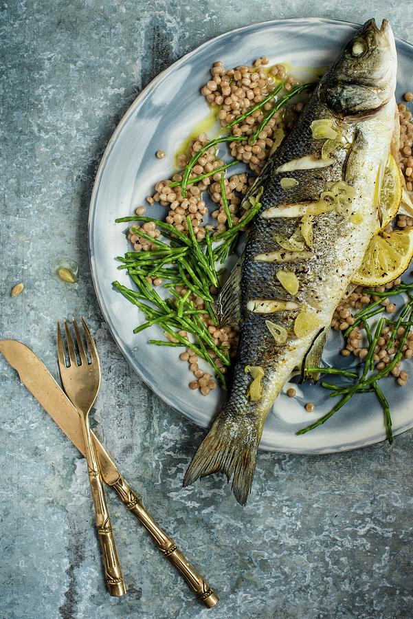 Fried Fish With Garlic And Lemons Photograph by Magdalena Hendey
