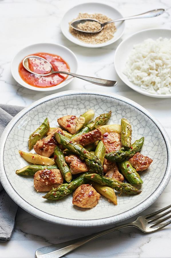 Fried Green Asparagus With Chicken Breasts In Sweet And Spicy Sauce With Rice And Sesame Seeds Photograph by Ulrike Emmert