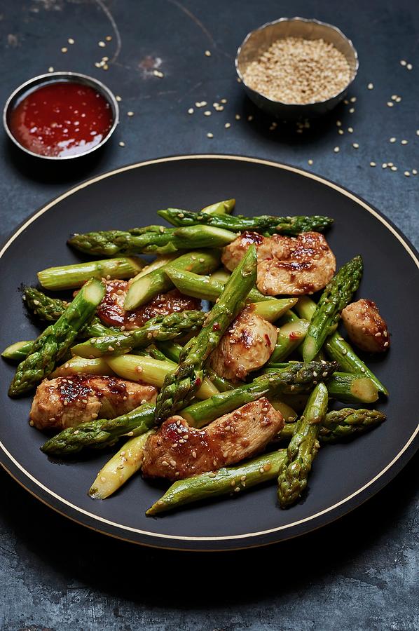 Fried Green Asparagus With Chicken Breasts In Sweet And Spicy Sauce With Sesame Seeds Photograph by Ulrike Emmert