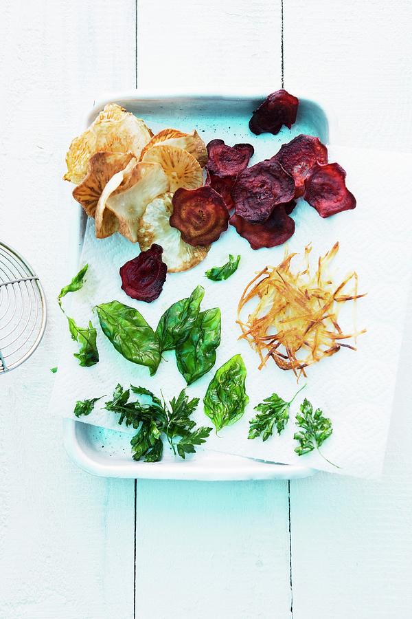Fried Herbs, Fried Vegetable Chips And Crispy Potato Lattice Photograph by Michael Wissing