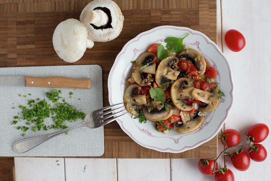 Fried Mushrooms And Tomatoes With Coriander Photograph by Claudia Timmann