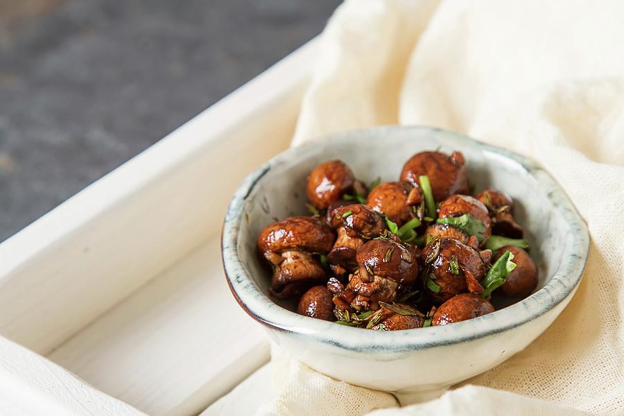 Fried Mushrooms Cooked With Italian Herbs In A Ceramic Bowl Photograph by Naltik