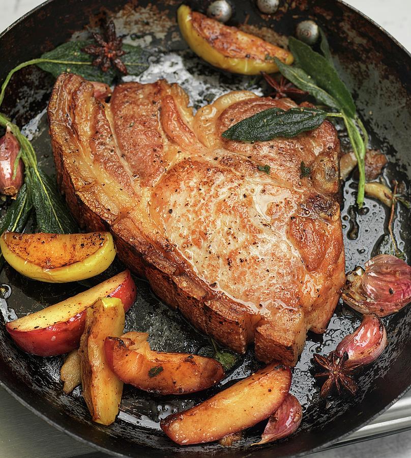 Fried Pork Chop With Apples And Sage In A Pan Photograph by Hugh Johnson