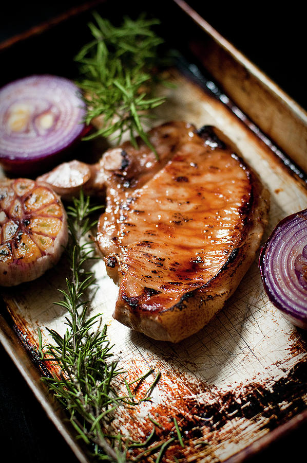 Fried Pork Chop With Red Onions, Garlic And Rosemary Photograph by Tomasz Jakusz