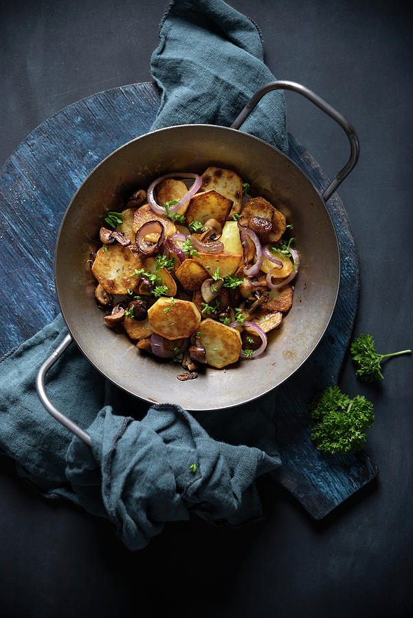 Fried Potatoes With Mushrooms And Red Onions In A Serving Pan Photograph by Kati Neudert