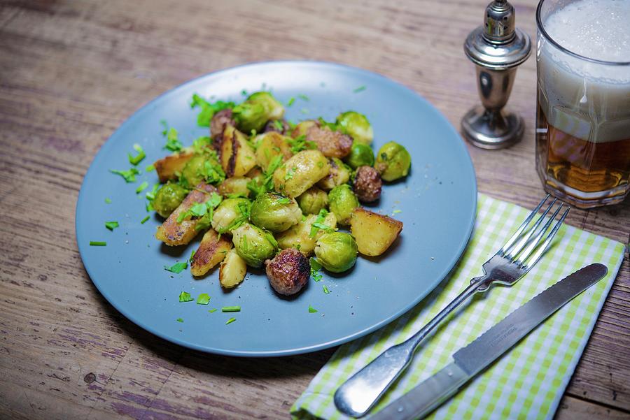 Fried Potatoes With Sausages And Brussels Sprouts Photograph by Sebastian Schollmeyer