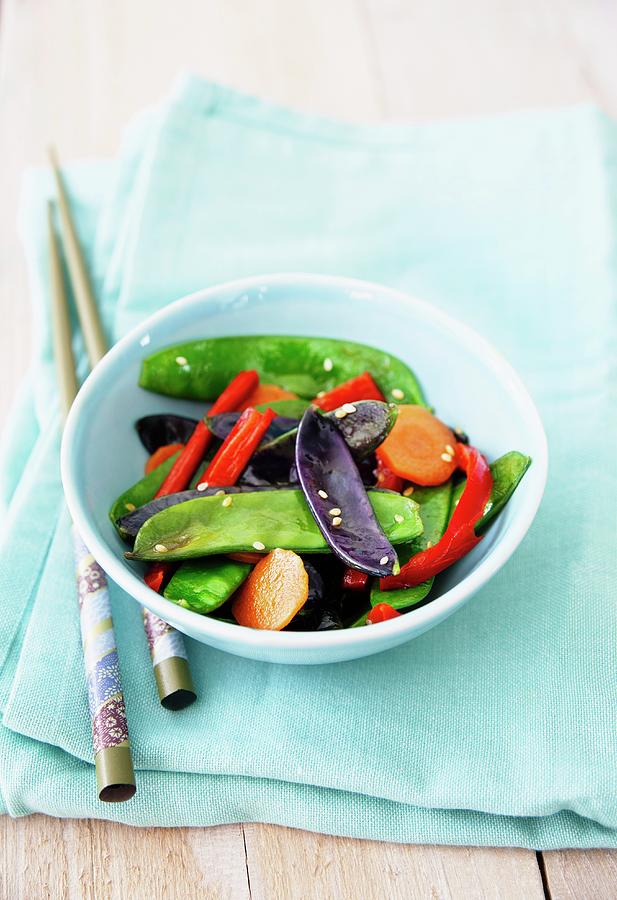 Fried Purple And Green Mange Tout With Carrots And Chilli Photograph by Victoria Firmston