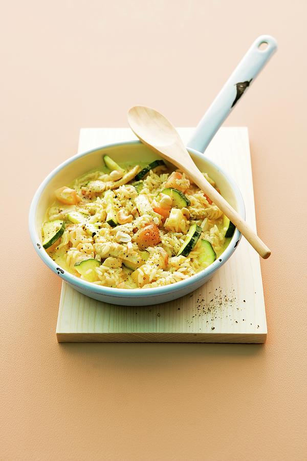 Fried Rice With Turkey Breast, Exotic Fruit And Courgette Photograph by Michael Wissing