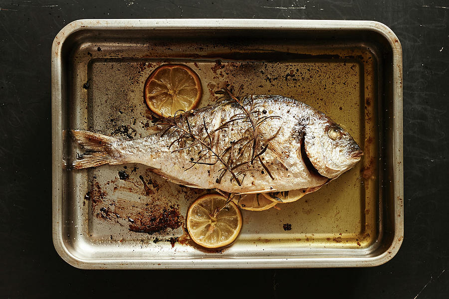 Fried Sea Bream With Lemons Photograph by Stefan Thurmann