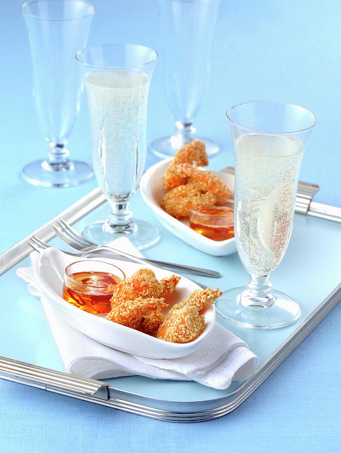 Fried Sesame Seed Prawns With A Chilli Dip And Glasses Of Champagne Photograph by Franco Pizzochero