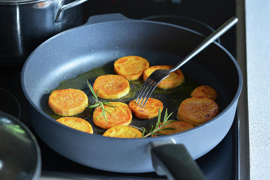 Fried Sweet Potato Slices With Oil In A Pan Photograph by Mariola Streim