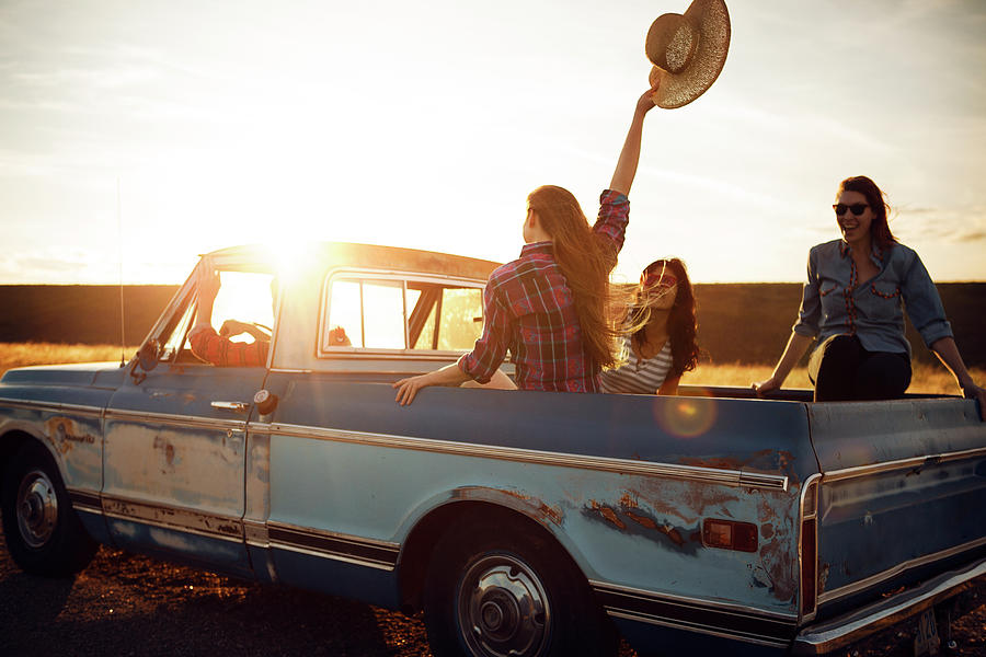 Friends Enjoying In Pick-up Truck During Sunset Photograph by Cavan ...