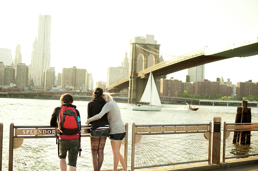 Brooklyn Bridge Photograph - Friends Standing On Promenade While Looking At Brooklyn Bridge In City by Cavan Images