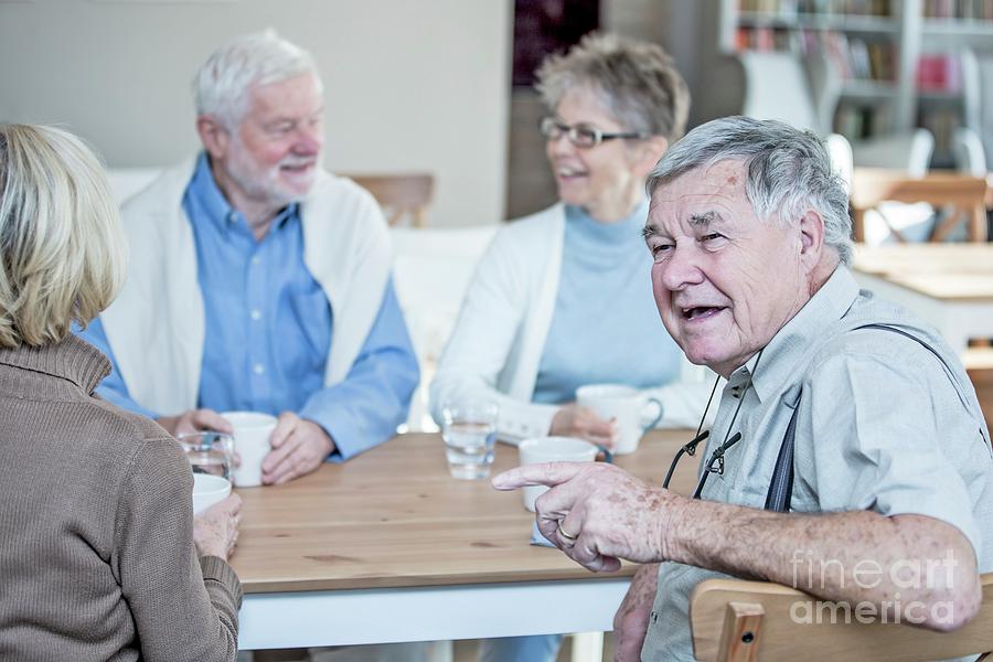 Friends Talking And Smiling In Retirement Home Photograph by Science Photo Library