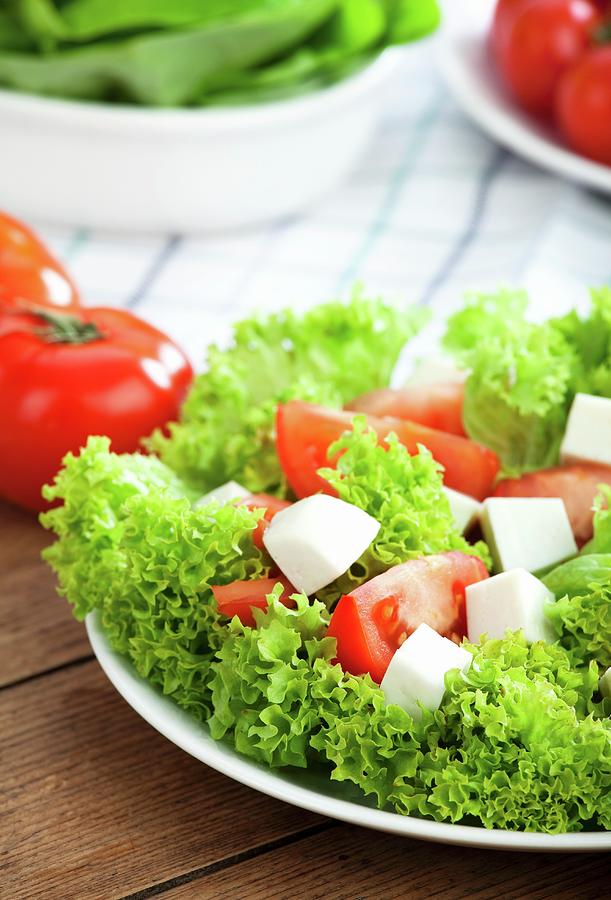 Frise Lettuce With Tomatoes And Mozzarella Photograph by Pawel Worytko