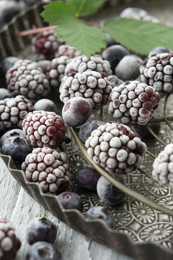 Frozen Blackberries And Blueberries With Blackberry Leaves Photograph by Martina Schindler