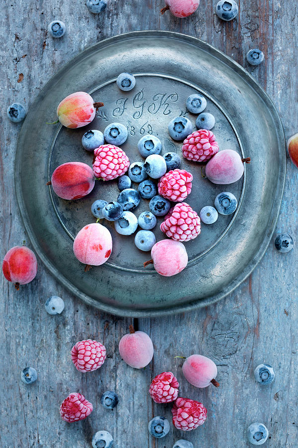 Frozen Blueberries, Gooseberries And Raspberries On An Old Zinc Plate Photograph by Sabine Lscher