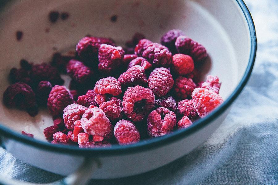 Frozen Raspberries In A Bowl Photograph by Kai Mitt
