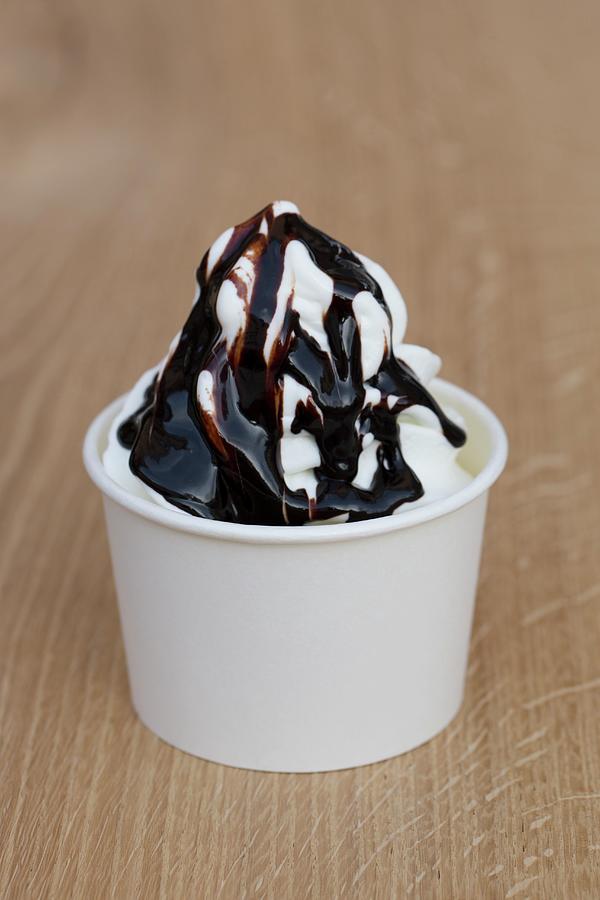 Frozen Yoghurt With Dark Chocolate Sauce Photograph by Esther Hildebrandt