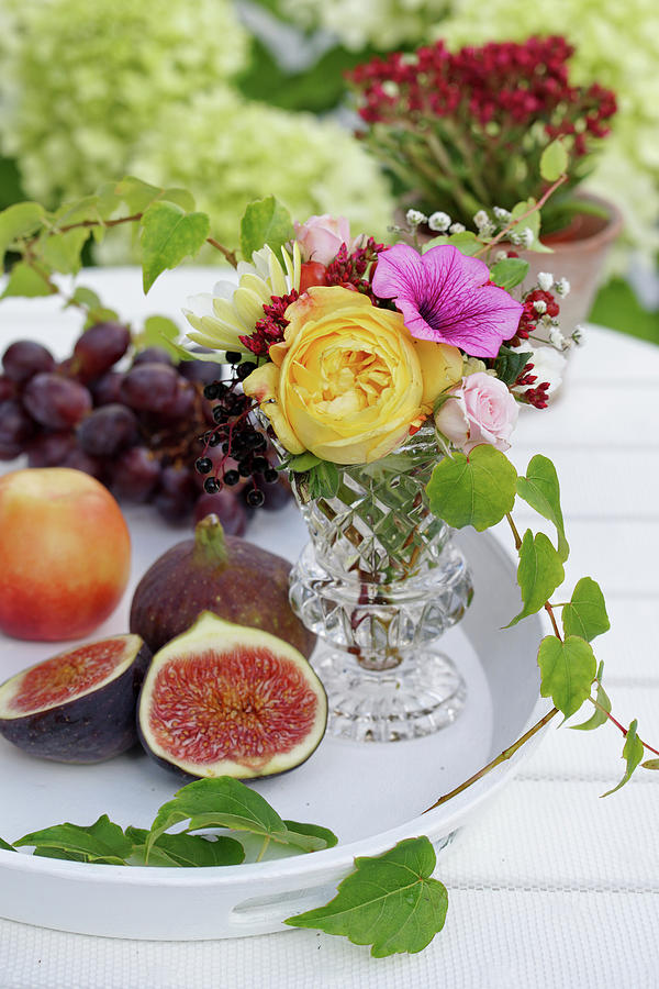 Fruit Next To A Bouquet Of Summer Flowers In A Vase On A Table Photograph by Angelica Linnhoff