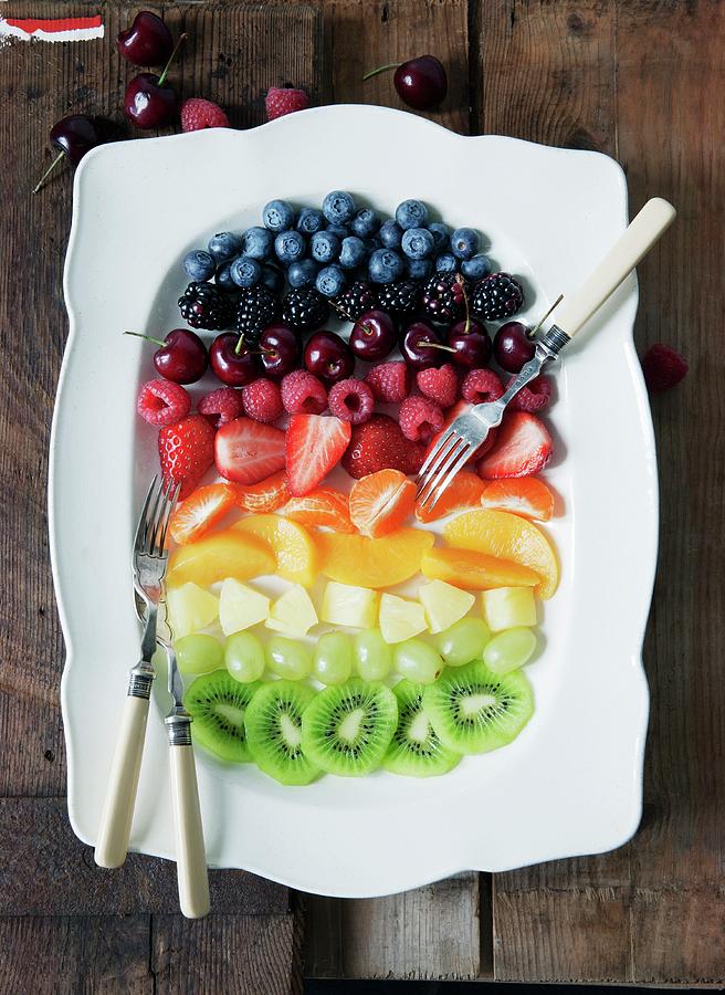 Fruit Salad Arranged In Rainbow Stripes On A Serving Platter Photograph by Victoria Firmston