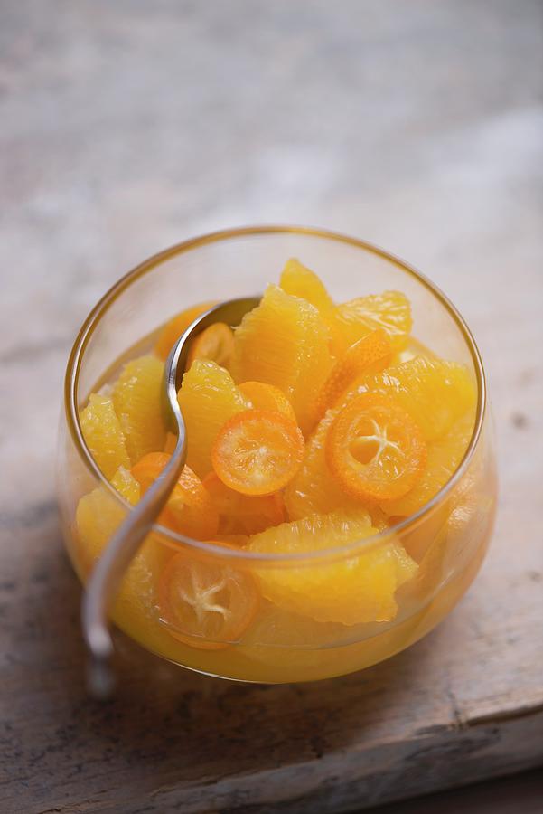 Fruit Salad Made Of Fresh Oranges And Kumquats In A Glass Bowl Photograph by Laurange