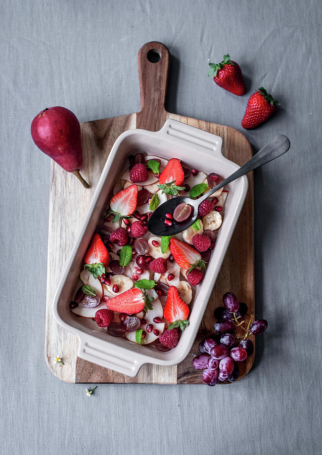 Fruit Salad With Berries, Pears, Pomegranate Seeds And Mint For Easter Photograph by Carolin Strothe