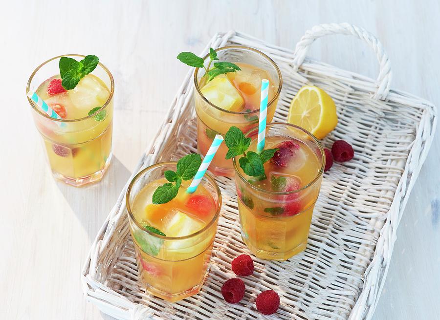 Fruity Iced Tea With Mint On A White Basket Tray Photograph by Stefan Schulte-ladbeck