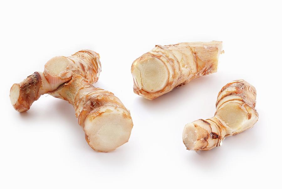Galangal On A White Surface Photograph by Petr Gross