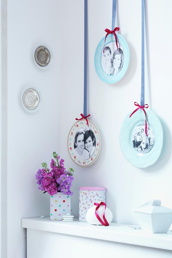 Gallery Of Photos On Plates Hung On Wall By Decorative Ribbons Photograph by Franziska Taube