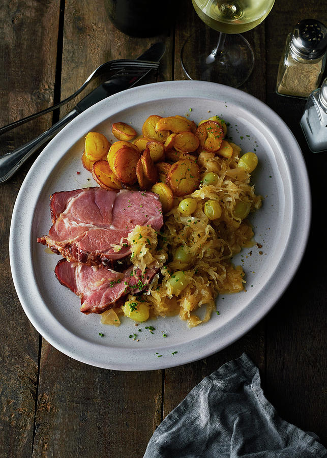 Gammon With Wine Sauerkraut, Fried Potatoes And A Glass Of White Wine Photograph by Stefan Schulte-ladbeck
