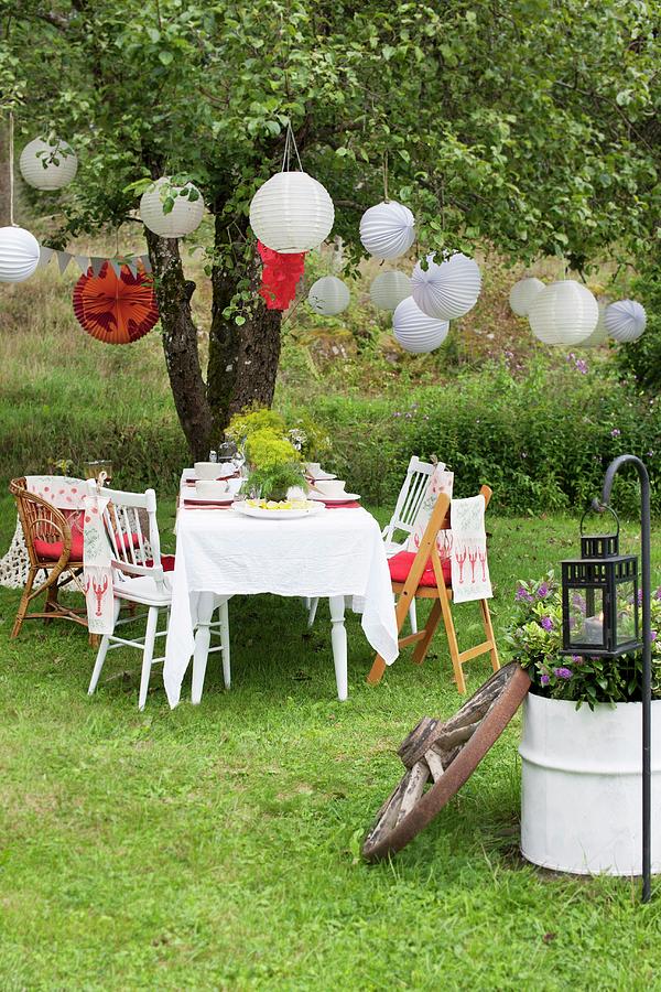 Garden Table Set For Swedish Crayfish Party Under Lanterns Hung From ...