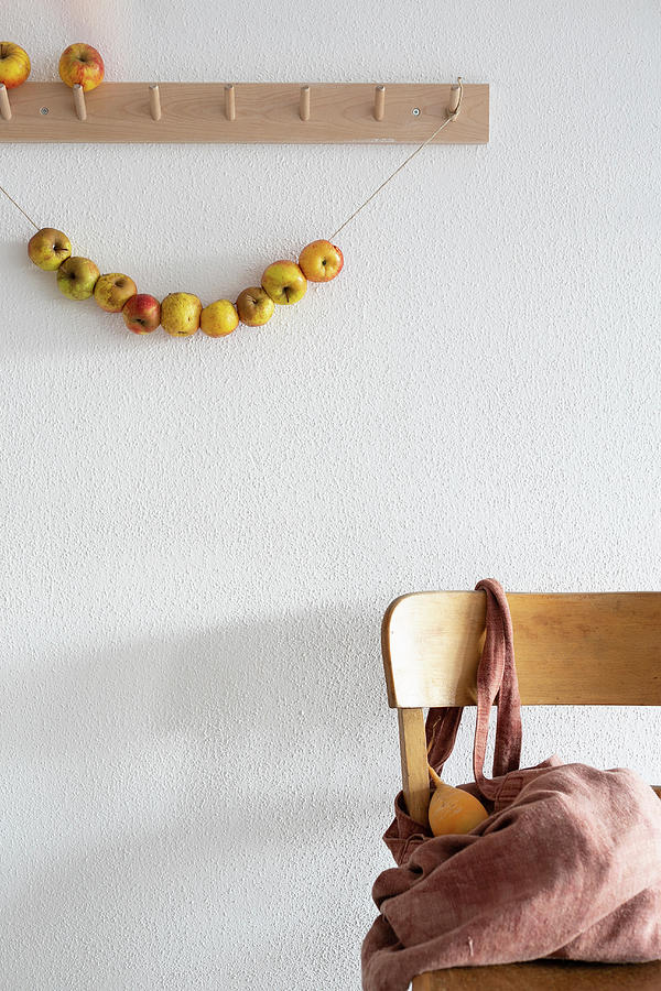 Garland Of Apples Hung From Coat Rack Photograph by Syl Loves