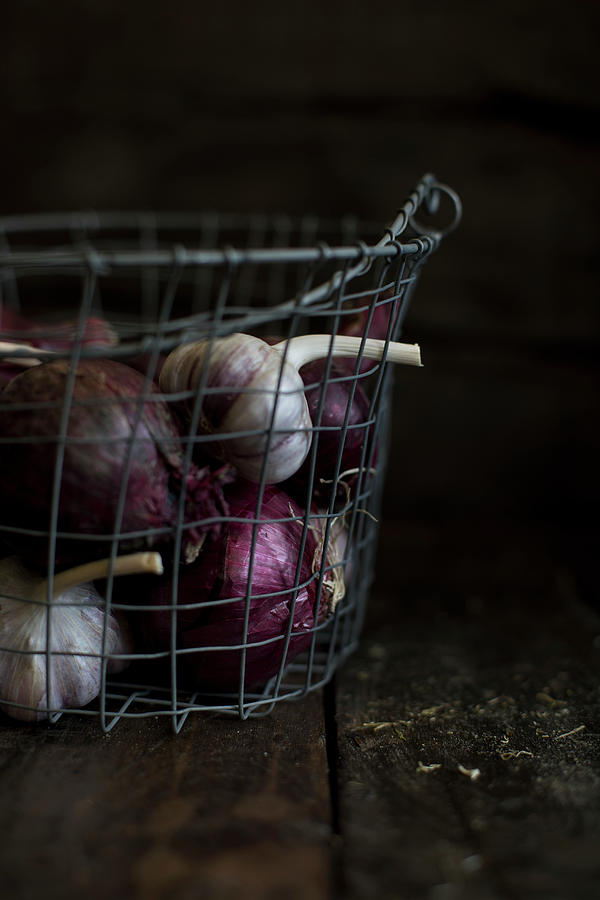Garlic And Red Onions In A Wire Basket Photograph by Lilia Jankowska