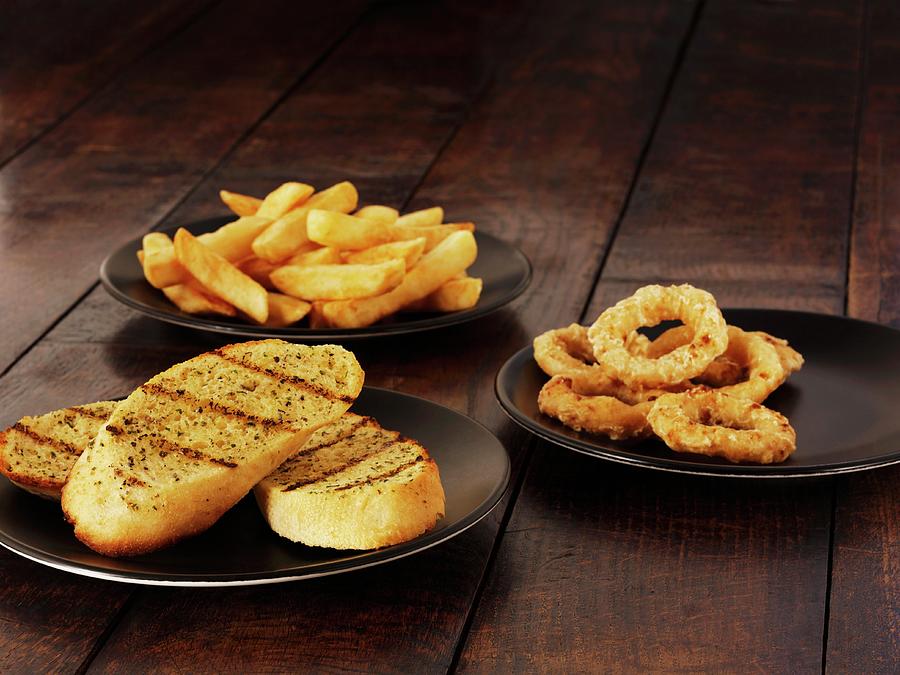 Garlic Bread, Onion Rings And Chips Photograph by Frank Adam