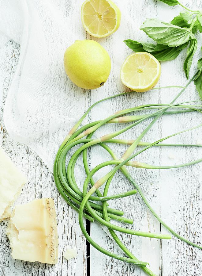 Garlic Chives, Lemons And Parmesan On Wooden Table Photograph by Clinton Hussey
