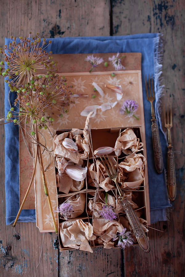 Garlic Cloves And Flowers Wrapped In Tissue Paper In Cardboard Box Photograph by Alicja Koll